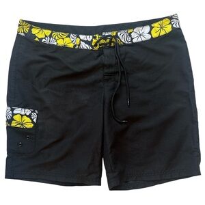 Lilu black board shorts with a yellow and white floral waistband and pocket trim